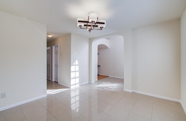 5330 Imperial Grove Dr, Houston, TX 77066 - spare room featuring arched walkways and light tile patterned flooring