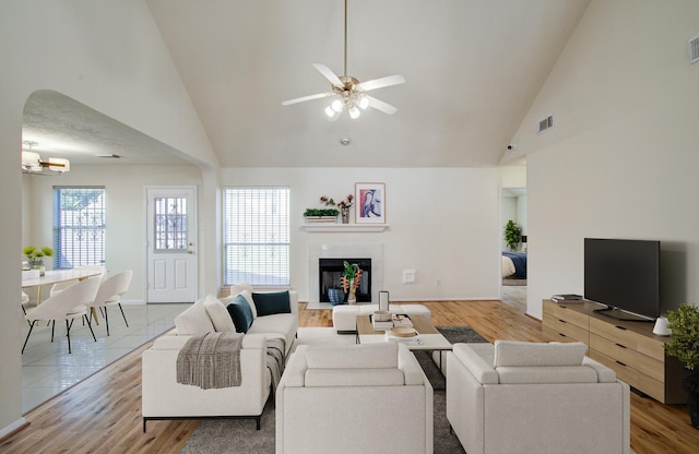 5330 Imperial Grove Dr, Houston, TX 77066 - living area featuring high vaulted ceiling, ceiling fan, wood finished floors, and a glass covered fireplace