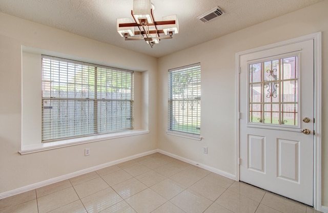 5330 Imperial Grove Dr, Houston, TX 77066 - entryway with a chandelier, light tile patterned floors, and a textured ceiling