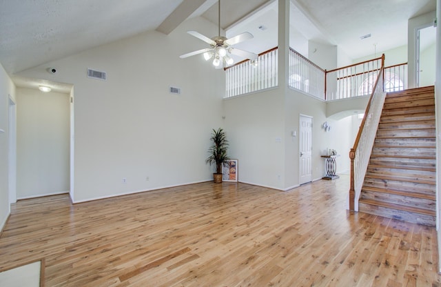 5330 Imperial Grove Dr, Houston, TX 77066 - unfurnished living room featuring high vaulted ceiling, light wood-style floors, a ceiling fan, stairs, and arched walkways
