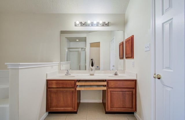 5330 Imperial Grove Dr, Houston, TX 77066 - full bathroom featuring double vanity, tile patterned flooring, a shower stall, a garden tub, and a textured ceiling