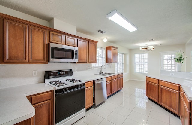 5330 Imperial Grove Dr, Houston, TX 77066 - kitchen with stainless steel appliances, a chandelier, and light countertops