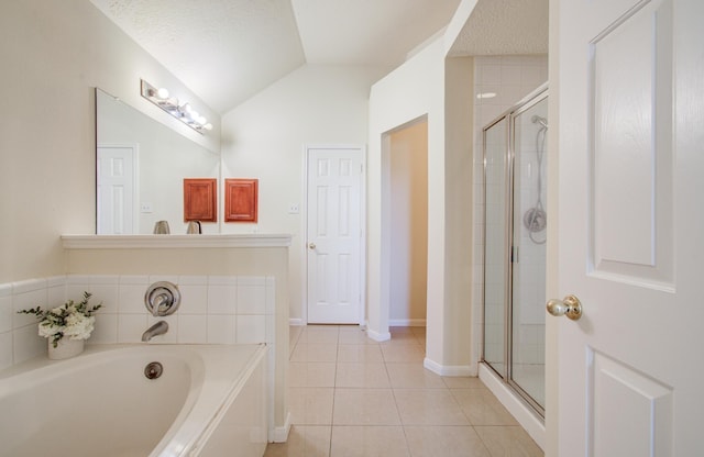 5330 Imperial Grove Dr, Houston, TX 77066 - bathroom with tile patterned flooring, a shower stall, a garden tub, lofted ceiling, and a textured ceiling
