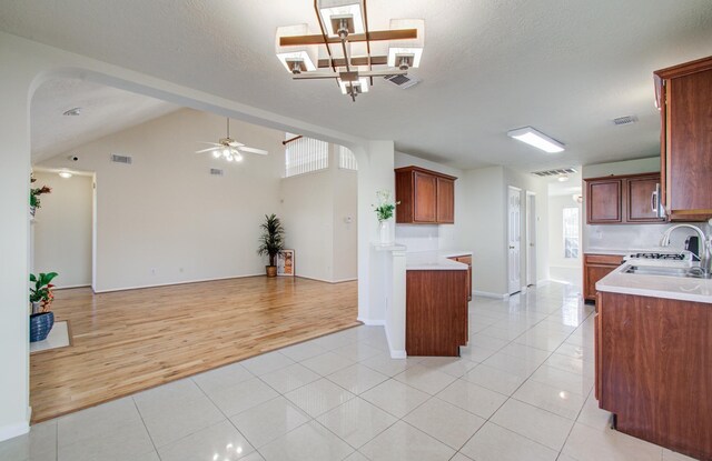 5330 Imperial Grove Dr, Houston, TX 77066 - kitchen with open floor plan, lofted ceiling, light tile patterned flooring, light countertops, and a ceiling fan
