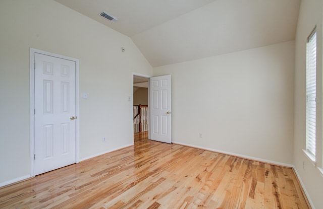 5330 Imperial Grove Dr, Houston, TX 77066 - unfurnished bedroom with vaulted ceiling, wood finished floors, and multiple windows