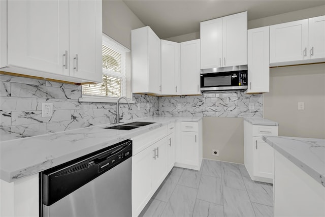 8004 Birmingham St A/B, Unit A/B Houston, TX 77028 - kitchen with appliances with stainless steel finishes, light stone countertops, white cabinets, decorative backsplash, and light marble finish floors