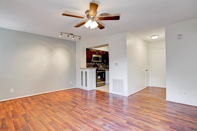 909 Silber Rd Unit 36, Houston, TX 77024 - unfurnished living room with a ceiling fan and light wood finished floors