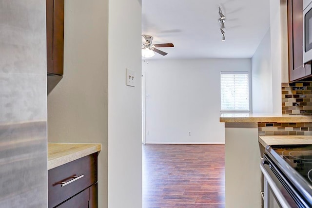 909 Silber Rd Unit 36, Houston, TX 77024 - kitchen with rail lighting, a ceiling fan, wood finished floors, backsplash, and electric range
