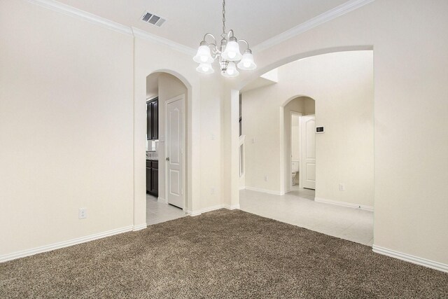 2311 Langley Dr, Rosharon, TX 77583 - unfurnished room with light colored carpet, arched walkways, crown molding, and a chandelier