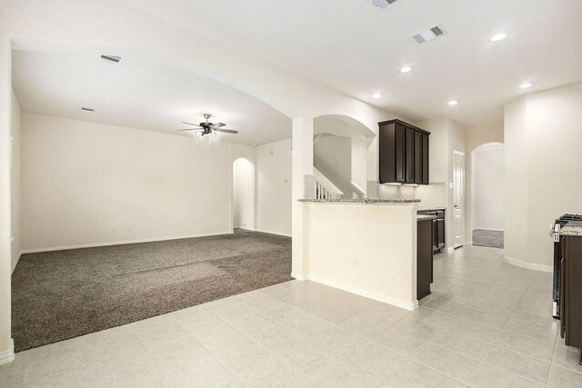 2311 Langley Dr, Rosharon, TX 77583 - kitchen with arched walkways, a ceiling fan, recessed lighting, light colored carpet, and open floor plan