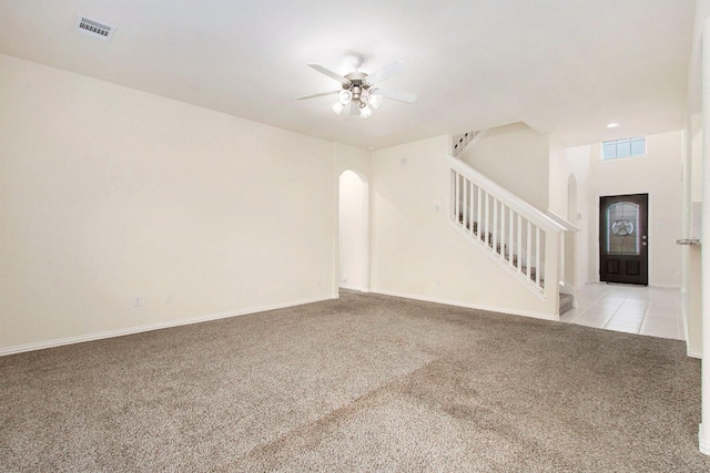 2311 Langley Dr, Rosharon, TX 77583 - unfurnished room featuring arched walkways, carpet, stairway, and a ceiling fan