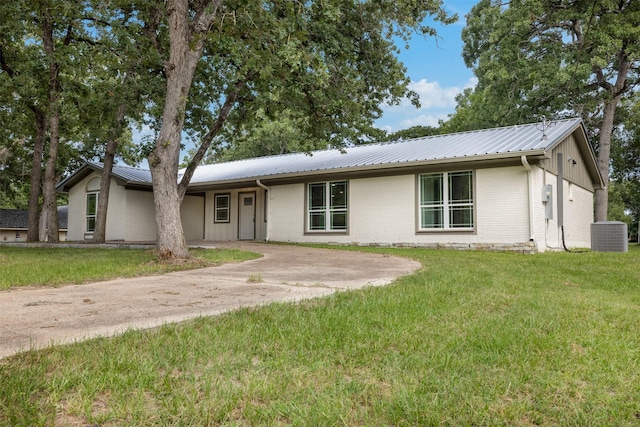 73 Fairway Dr, Normangee, TX 77871 - single story home with a front lawn, a metal roof, and brick siding