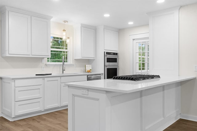 73 Fairway Dr, Normangee, TX 77871 - kitchen with appliances with stainless steel finishes, healthy amount of natural light, white cabinetry, a peninsula, and recessed lighting