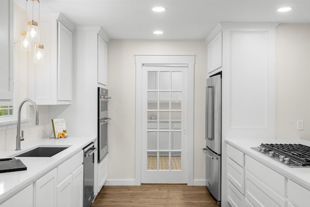 73 Fairway Dr, Normangee, TX 77871 - kitchen with stainless steel appliances, wood finished floors, white cabinets, recessed lighting, and light countertops