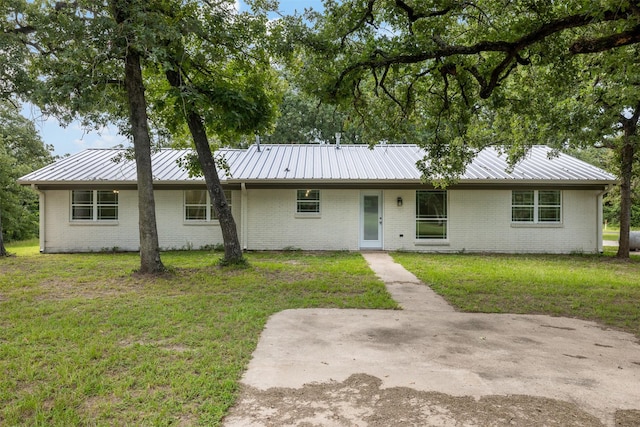 73 Fairway Dr, Normangee, TX 77871 - single story home with a metal roof, a front lawn, and brick siding