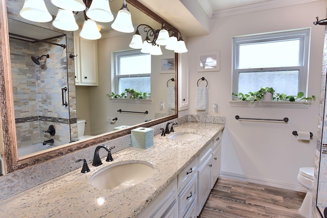 5926 Lattimer Dr, Houston, TX 77035 - bathroom with ornamental molding, wood finished floors, double vanity, a chandelier, and enclosed tub / shower combo