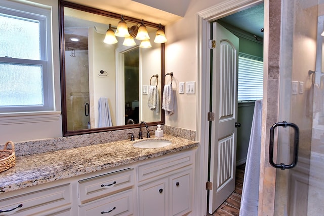 5926 Lattimer Dr, Houston, TX 77035 - bathroom with vanity, healthy amount of natural light, a shower stall, and wood finished floors