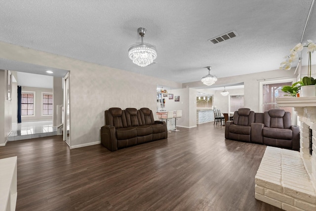 9827 Gold Cup Way, Houston, TX 77065 - living room with a chandelier, dark wood finished floors, and a textured ceiling