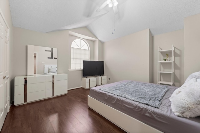 9827 Gold Cup Way, Houston, TX 77065 - bedroom with dark wood-type flooring, lofted ceiling, a ceiling fan, and a textured ceiling
