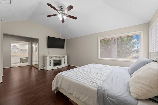9827 Gold Cup Way, Houston, TX 77065 - bedroom featuring a fireplace, lofted ceiling, dark wood-style floors, and a ceiling fan
