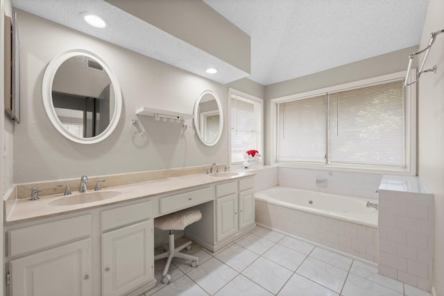 9827 Gold Cup Way, Houston, TX 77065 - bathroom with a garden tub, double vanity, tile patterned floors, recessed lighting, and a textured ceiling