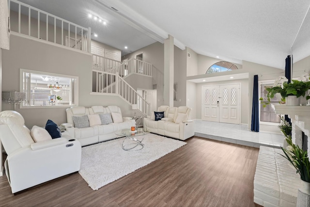 9827 Gold Cup Way, Houston, TX 77065 - living room with wood finished floors, stairway, recessed lighting, high vaulted ceiling, and a fireplace