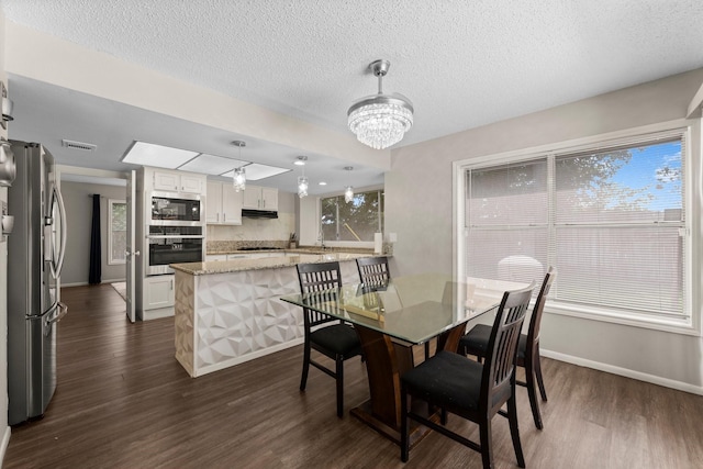 9827 Gold Cup Way, Houston, TX 77065 - dining space with dark wood-type flooring, a chandelier, and a textured ceiling