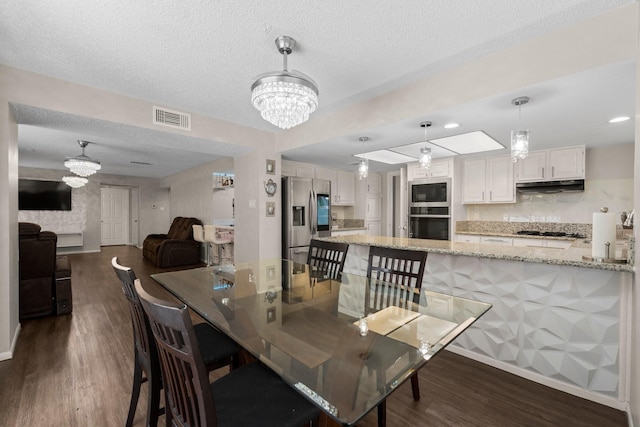 9827 Gold Cup Way, Houston, TX 77065 - dining room with a chandelier, dark wood-type flooring, and a textured ceiling