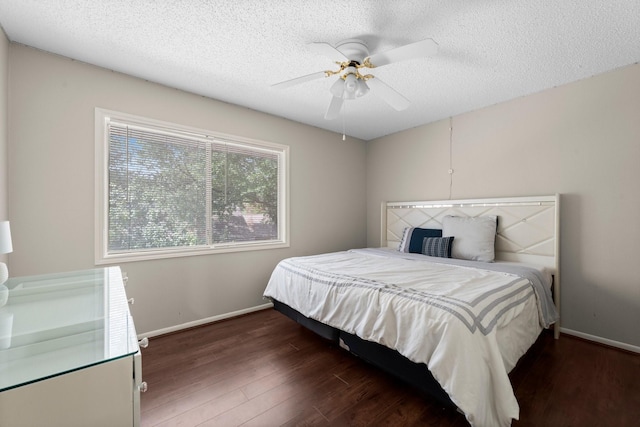 9827 Gold Cup Way, Houston, TX 77065 - bedroom featuring wood finished floors, a textured ceiling, and a ceiling fan