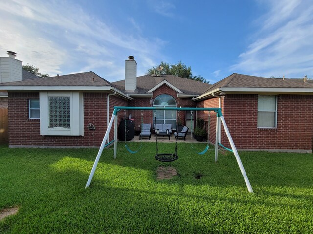 3214 Worthington Dr, Pearland, TX 77584 - rear view of property with brick siding, a playground, a chimney, a patio, and a yard
