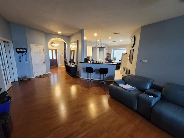 3214 Worthington Dr, Pearland, TX 77584 - living area featuring dark wood-style flooring, arched walkways, and recessed lighting