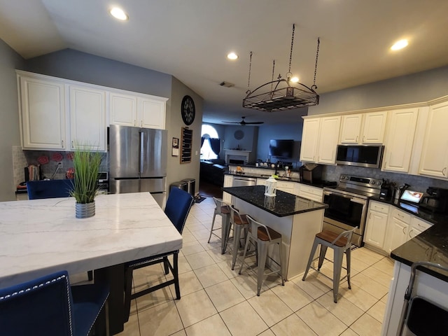 3214 Worthington Dr, Pearland, TX 77584 - kitchen featuring stainless steel appliances, ceiling fan, backsplash, light tile patterned flooring, and recessed lighting