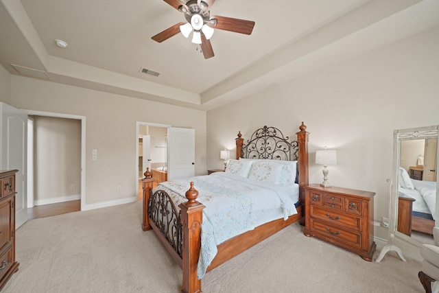 19831 Indigo Key Ct, Cypress, TX 77433 - bedroom with light colored carpet, a raised ceiling, ensuite bathroom, and ceiling fan