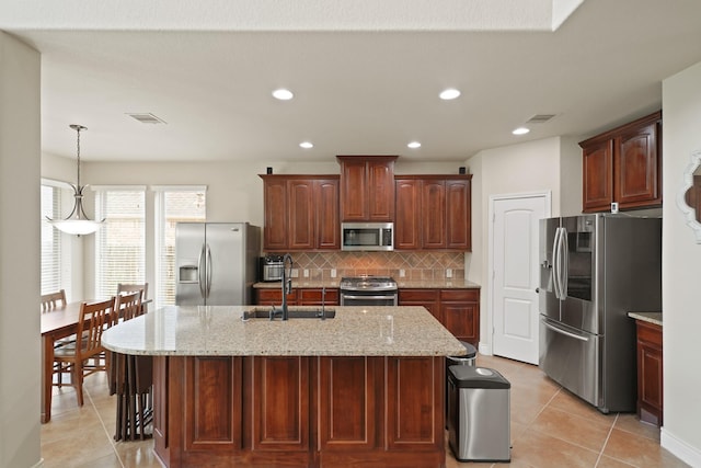 19831 Indigo Key Ct, Cypress, TX 77433 - kitchen with appliances with stainless steel finishes, light tile patterned flooring, decorative backsplash, light stone counters, and recessed lighting