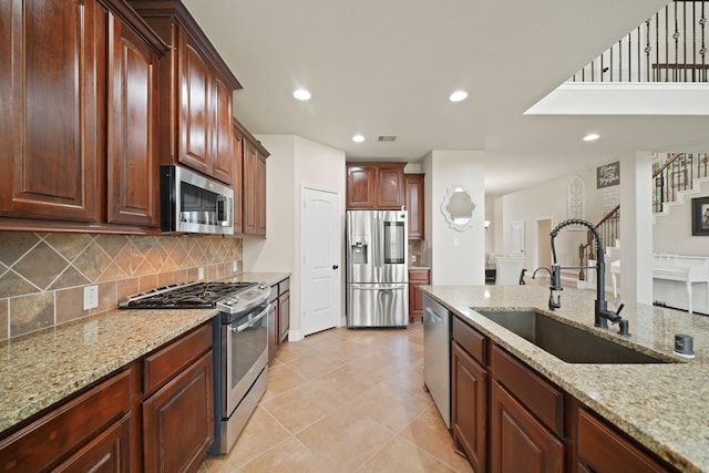19831 Indigo Key Ct, Cypress, TX 77433 - kitchen with appliances with stainless steel finishes, tasteful backsplash, light stone countertops, recessed lighting, and light tile patterned floors