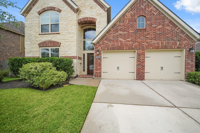 19831 Indigo Key Ct, Cypress, TX 77433 - french country home with stone siding, driveway, a front yard, brick siding, and an attached garage