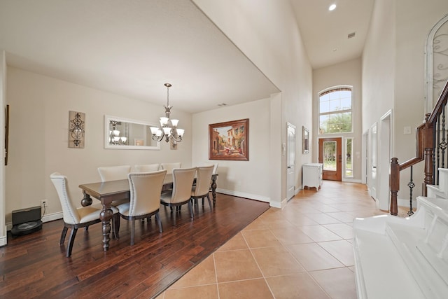 19831 Indigo Key Ct, Cypress, TX 77433 - dining space featuring stairs, a chandelier, a high ceiling, tile patterned flooring, and recessed lighting