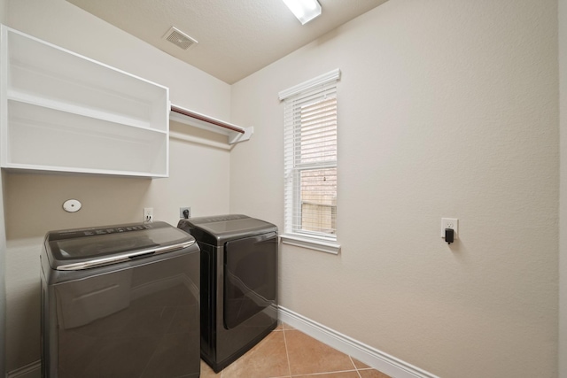 19831 Indigo Key Ct, Cypress, TX 77433 - laundry room with washing machine and clothes dryer and light tile patterned floors