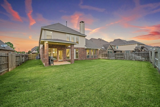 19831 Indigo Key Ct, Cypress, TX 77433 - rear view of property with brick siding, a chimney, a patio, and a fenced backyard