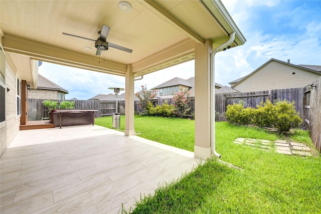 11442 Harmony Summit Trce, Richmond, TX 77406 - fenced backyard with ceiling fan, a patio, and a hot tub