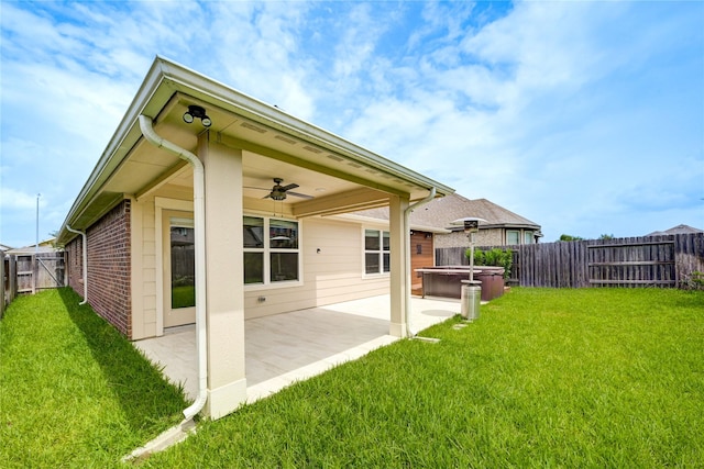 11442 Harmony Summit Trce, Richmond, TX 77406 - back of house with a hot tub, a ceiling fan, a fenced backyard, a patio area, and brick siding