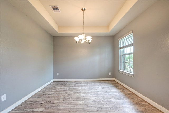 11442 Harmony Summit Trce, Richmond, TX 77406 - empty room with a tray ceiling, a chandelier, and wood finished floors