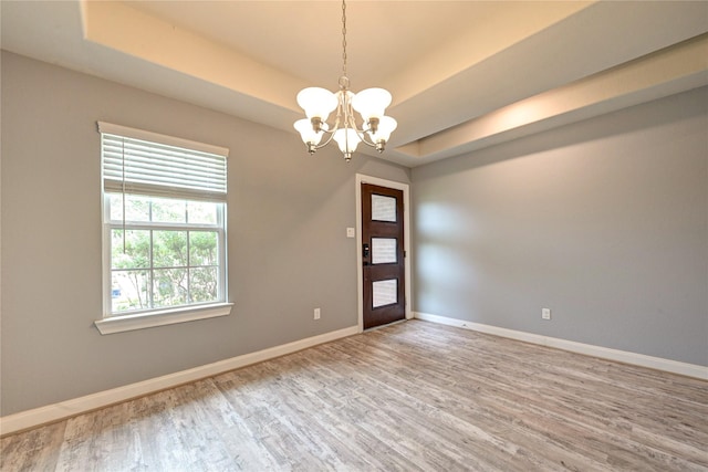 11442 Harmony Summit Trce, Richmond, TX 77406 - spare room featuring wood finished floors, a chandelier, and a tray ceiling