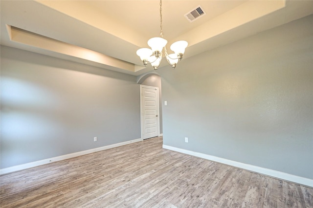 11442 Harmony Summit Trce, Richmond, TX 77406 - spare room with a tray ceiling, wood finished floors, and a chandelier