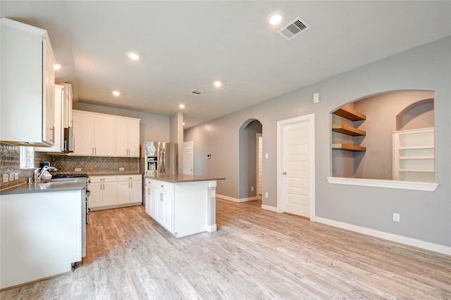 11442 Harmony Summit Trce, Richmond, TX 77406 - kitchen featuring a center island, tasteful backsplash, light wood-style flooring, stainless steel fridge with ice dispenser, and recessed lighting
