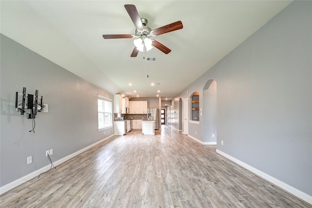 11442 Harmony Summit Trce, Richmond, TX 77406 - unfurnished living room with arched walkways, light wood-style floors, ceiling fan, and recessed lighting