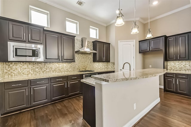 6107 Stillman St, Houston, TX 77007 - kitchen with wall chimney exhaust hood, stainless steel microwave, backsplash, dark wood-style floors, and crown molding