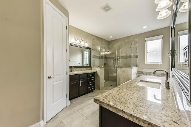 6107 Stillman St, Houston, TX 77007 - full bathroom featuring two vanities, a stall shower, and tile patterned floors