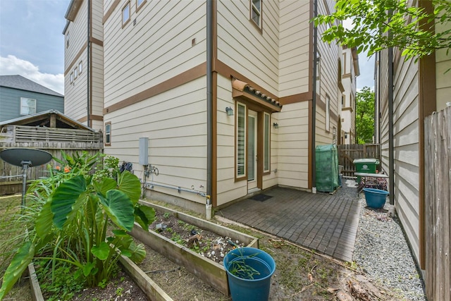 6107 Stillman St, Houston, TX 77007 - view of home's exterior featuring a fenced backyard, a patio area, and a garden