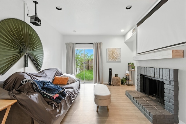 9809 Richmond Ave Unit H10, Houston, TX 77042 - living area featuring wood finished floors, a fireplace, and recessed lighting